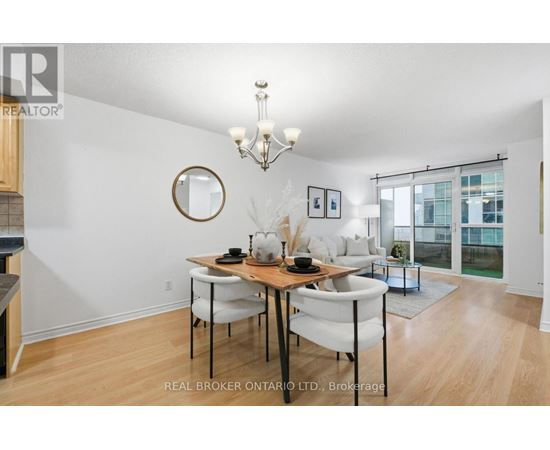 A dining room with a wooden table and chairs.