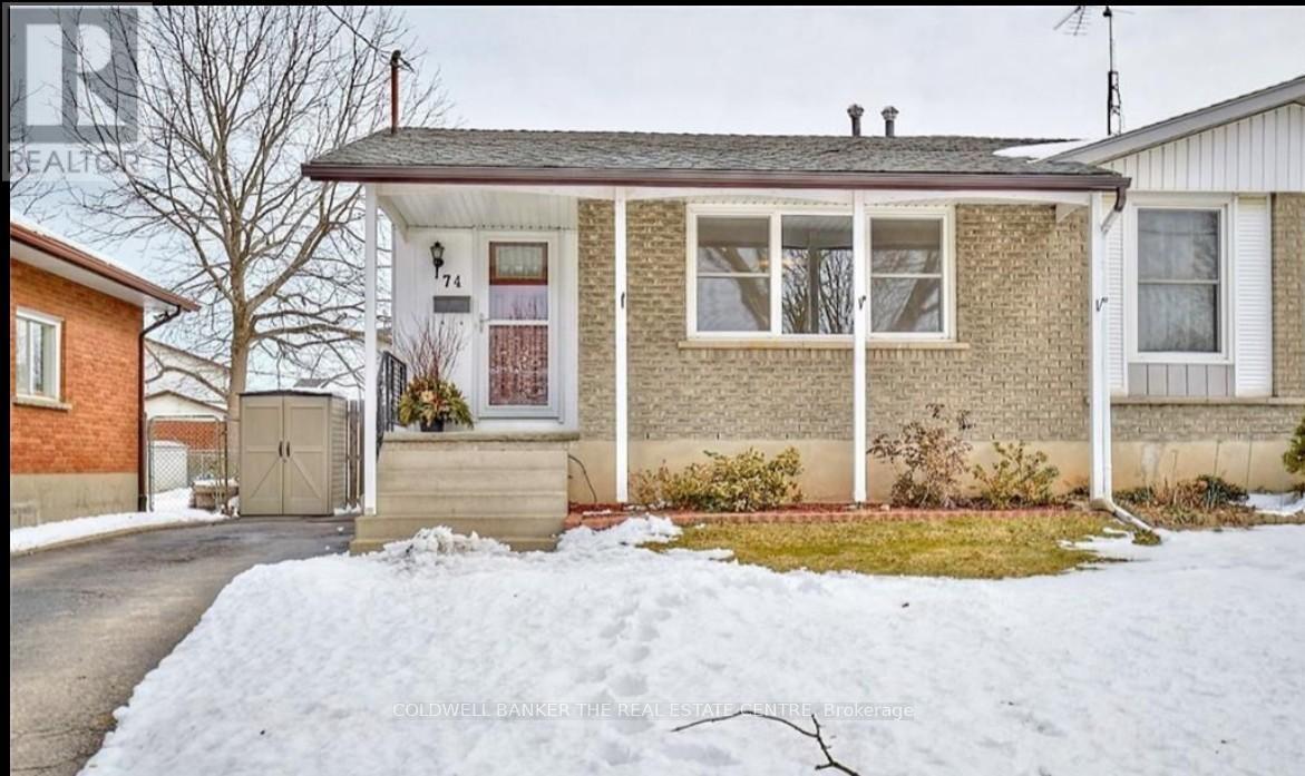 A house with a snow-covered ground in front.