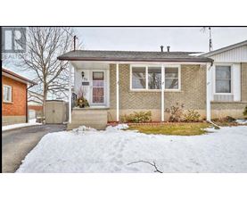A house with a snow-covered ground in front.