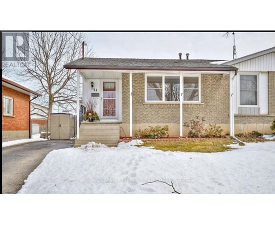 A house with a snow-covered ground in front.