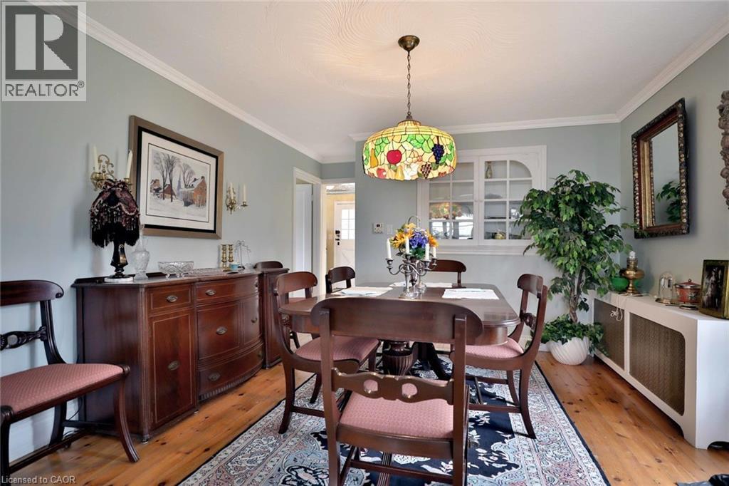 A dining room with a wooden table and chairs.