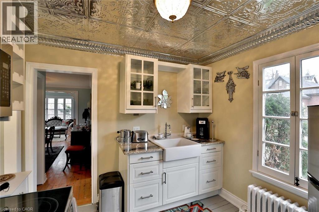 A kitchen with a stove top oven and a sink.