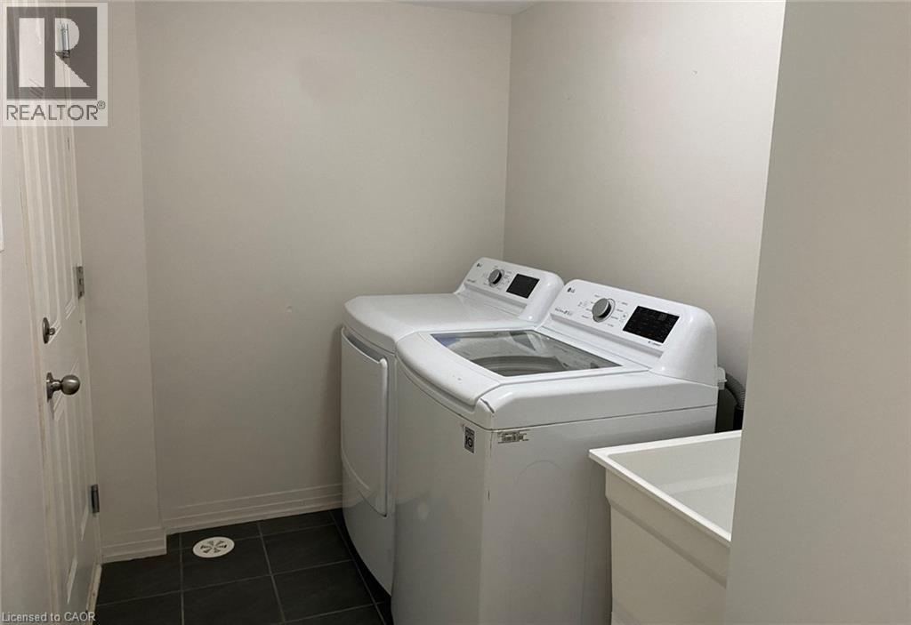 A small laundry room with a washer and dryer.