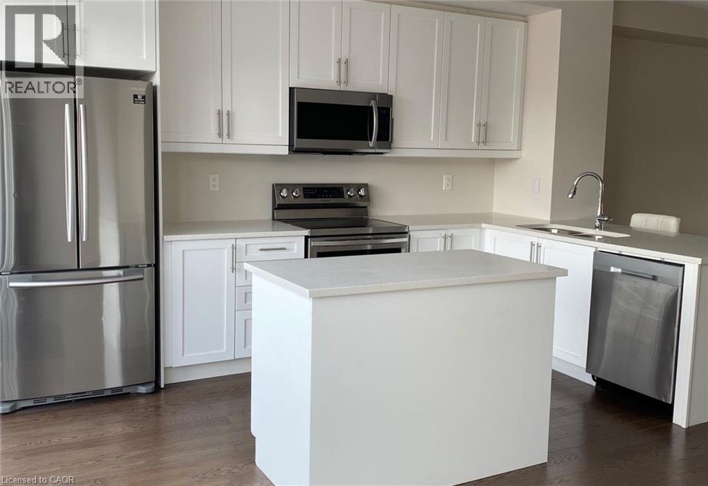 A kitchen with white cabinets and a white island.