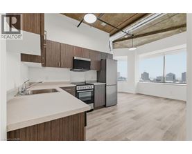 A kitchen with wooden cabinets and a stainless steel oven.