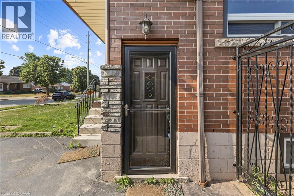 A house with a black door and a brick wall.