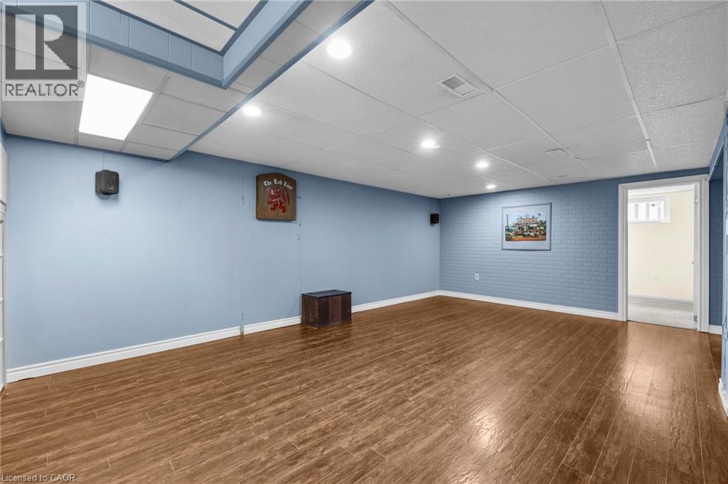 A room with wooden flooring and a painting on the wall.