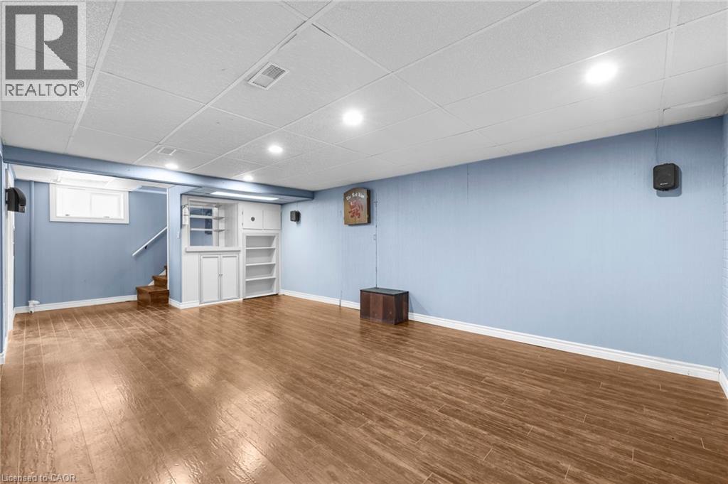 A room with wooden flooring and a blue wall.