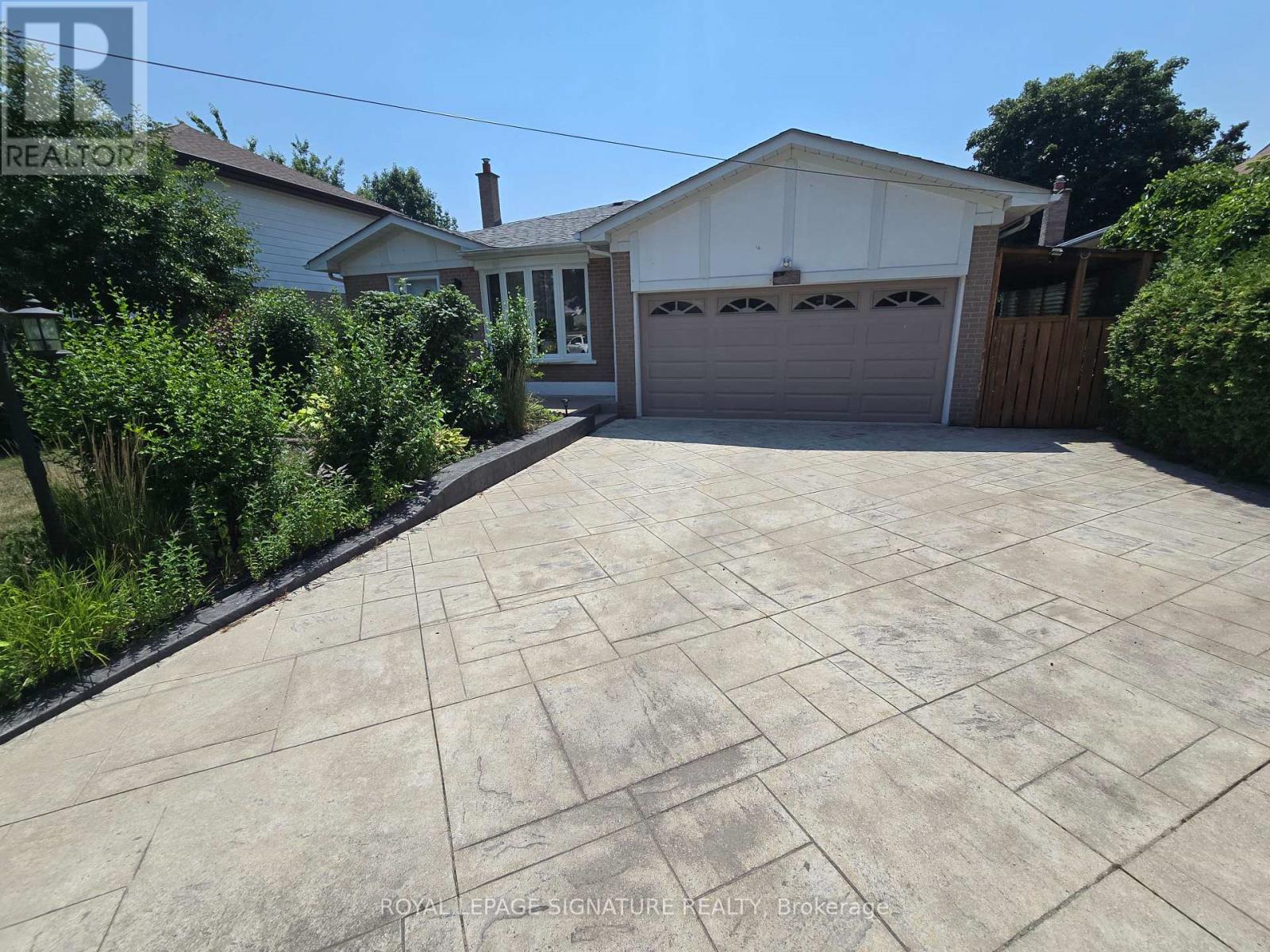 A house with a driveway in front of it.