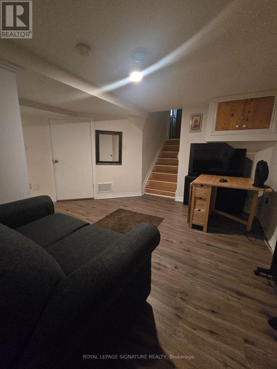A living room with a couch and a television.