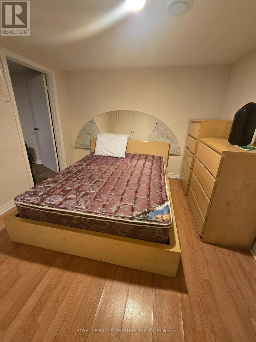 A bedroom with a bed, nightstand, and a dresser.