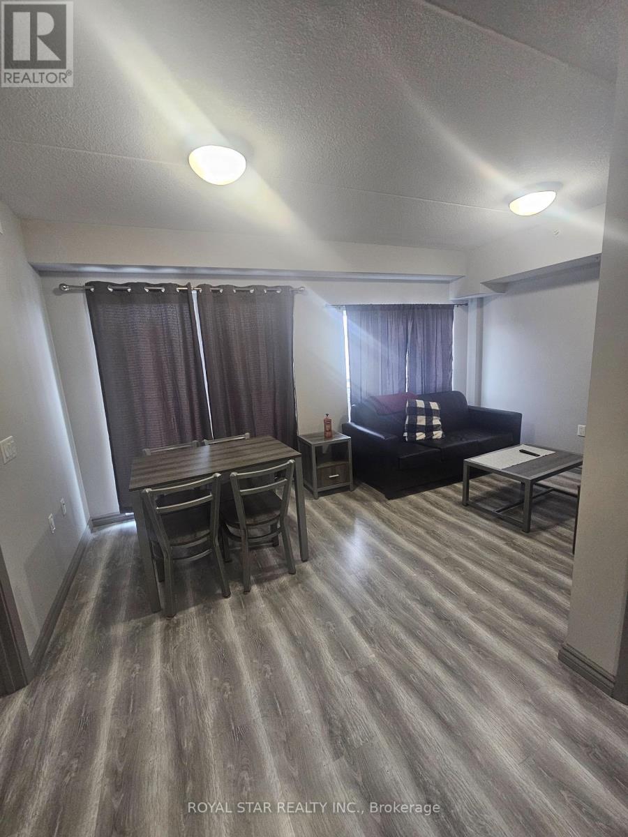 A living room with a couch, chairs, and a dining table.