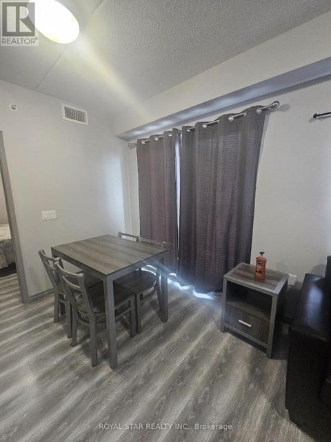 A dining room with a table and chairs.