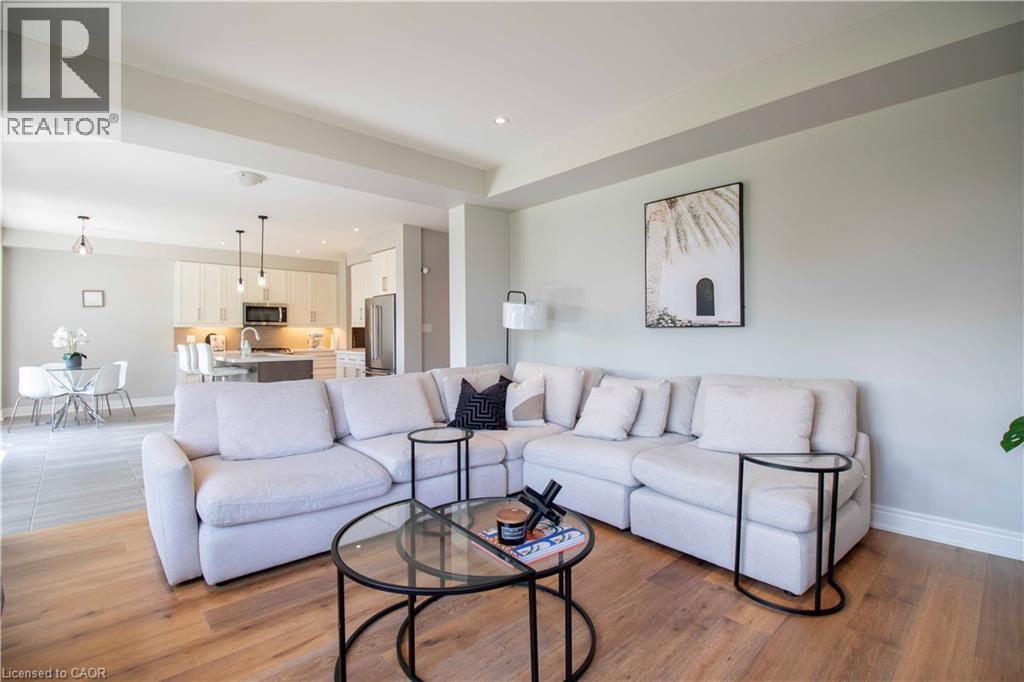 A living room with a white couch and a glass coffee table.