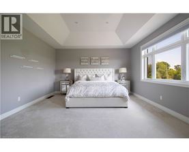 A bedroom with a large bed and a window.