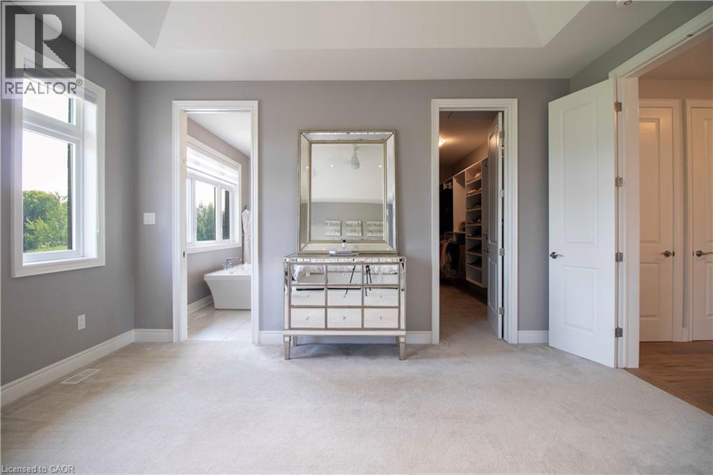 A well-lit, spacious room with a large mirror and a built-in cabinet.
