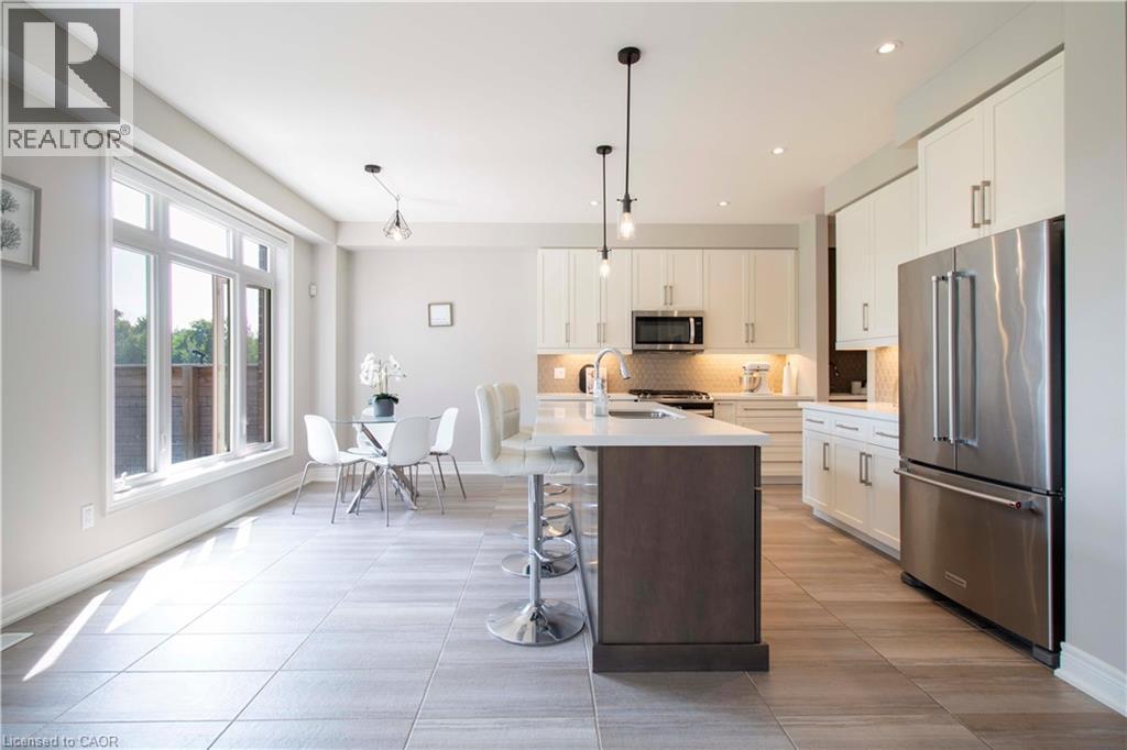 A modern kitchen with a dining table and chairs.