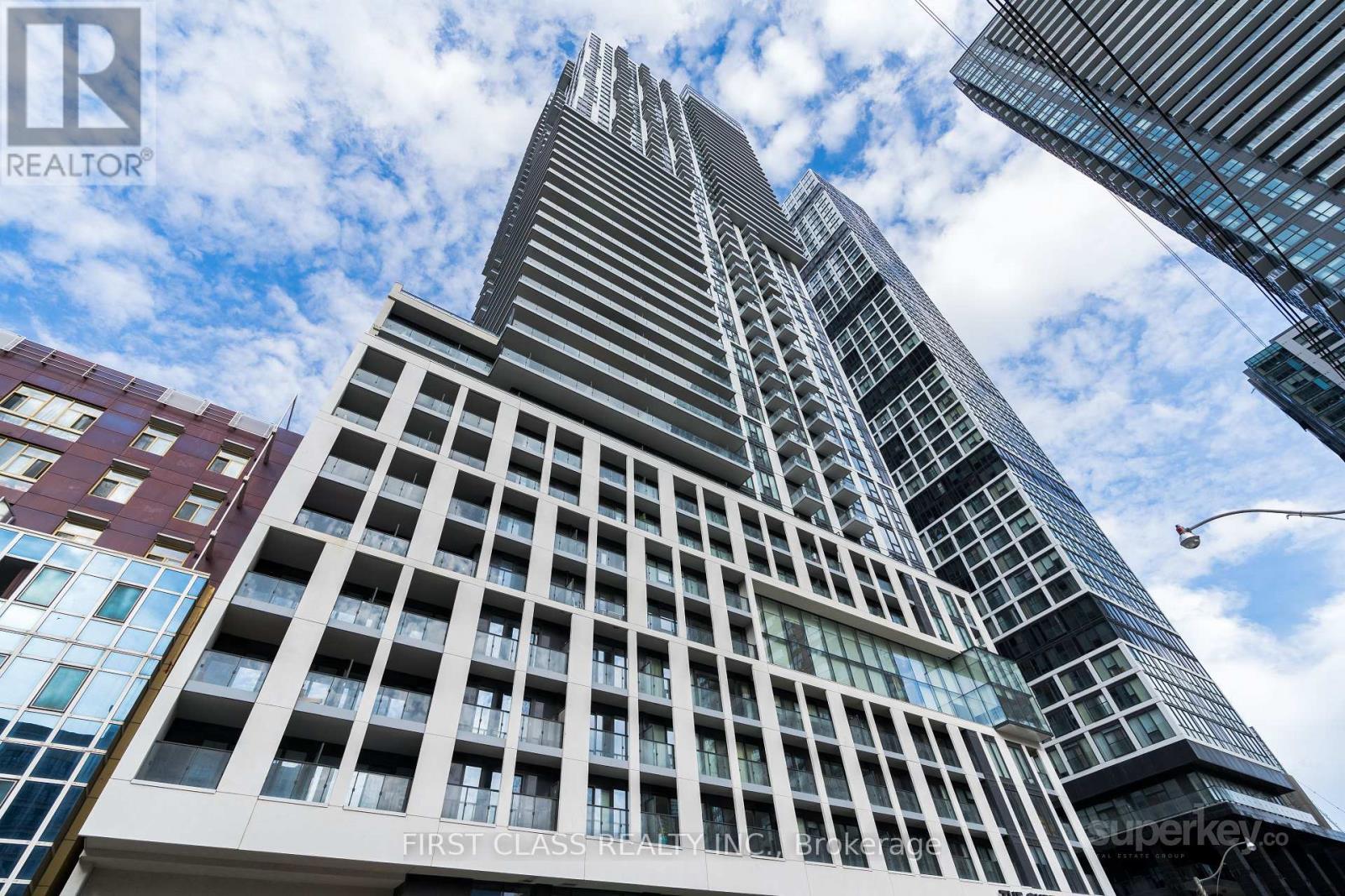 A tall building with the words "First Class Realty" on the side.