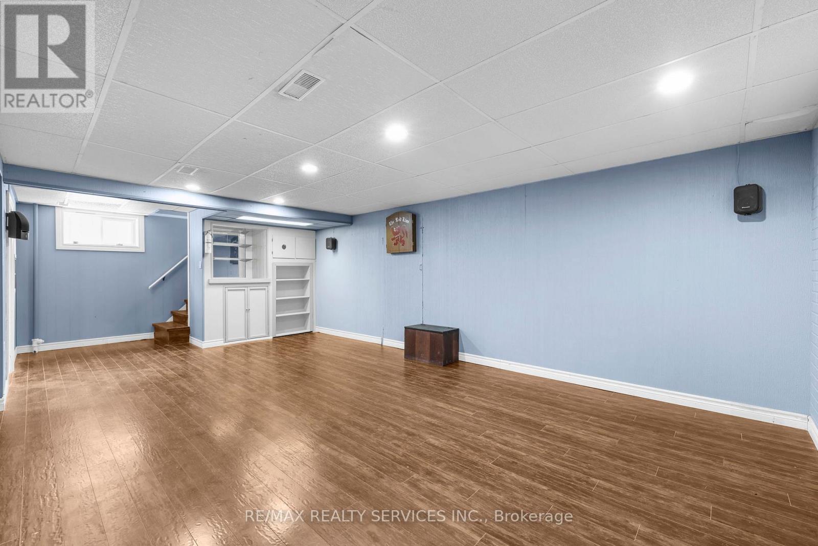 A room with wooden flooring and a white door.