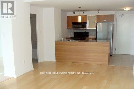 A kitchen with wooden floors and white walls.