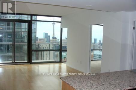 A real estate company is advertising a property with a large open space and a view of the city.