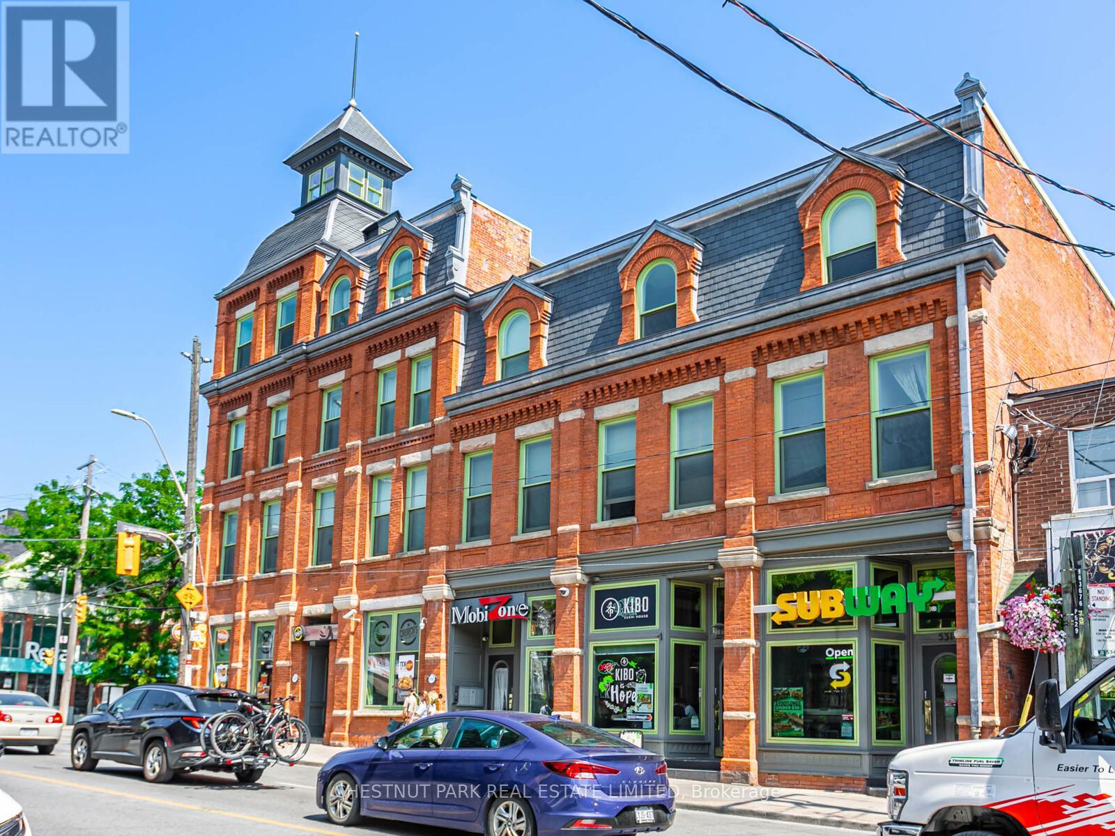 A street view of a building with a sign that says "SUBWAY" on it.