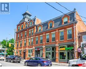 A street view of a building with a sign that says "SUBWAY" on it.