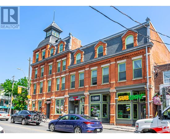 A street view of a building with a sign that says "SUBWAY" on it.