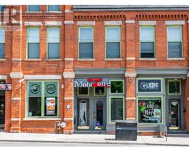 A red brick building with a Mobil One gas station on the ground floor.