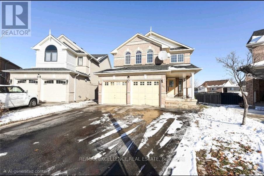 A large, two-story house with a garage is surrounded by a snowy landscape.