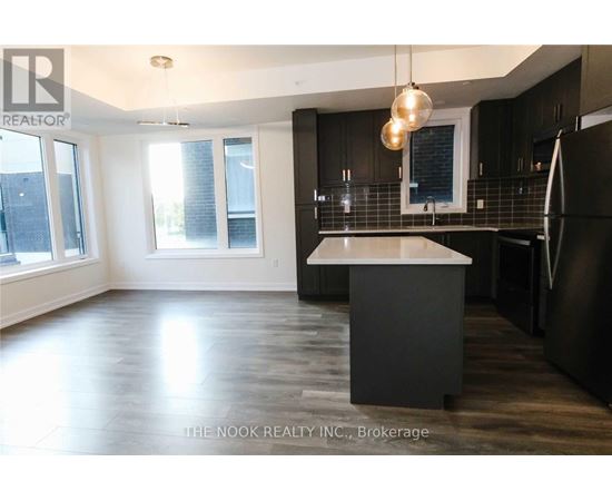 A modern kitchen with dark wood cabinets and a white island.