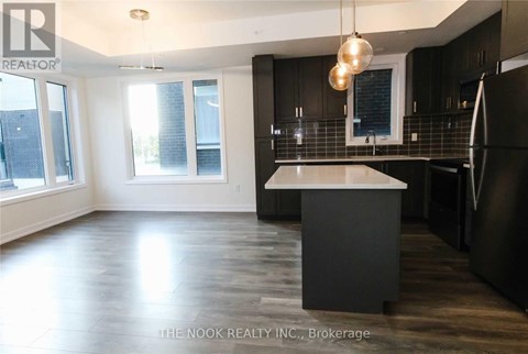 A modern kitchen with dark wood cabinets and a white island.