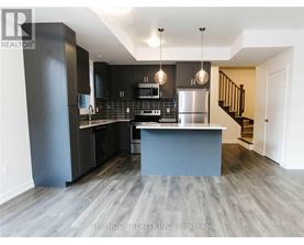 A modern kitchen with a large island and stainless steel appliances.