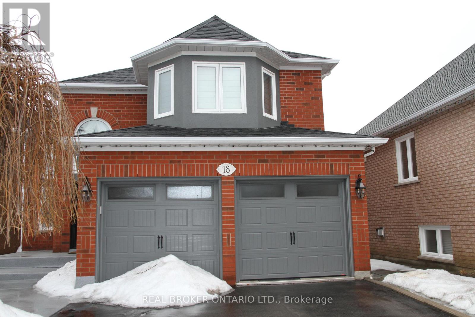 A house with a grey garage door is for sale in Brokerage.