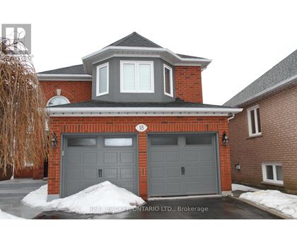 A house with a grey garage door is for sale in Brokerage.