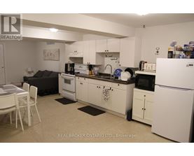 A kitchen with white appliances and cabinets.