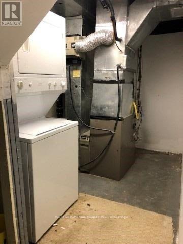 A large industrial machine is in a room with a beige mat on the floor.