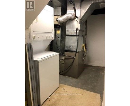 A large industrial machine is in a room with a beige mat on the floor.