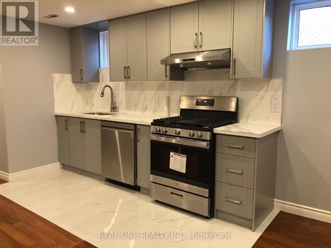 A modern kitchen with a stainless steel oven and white countertops.
