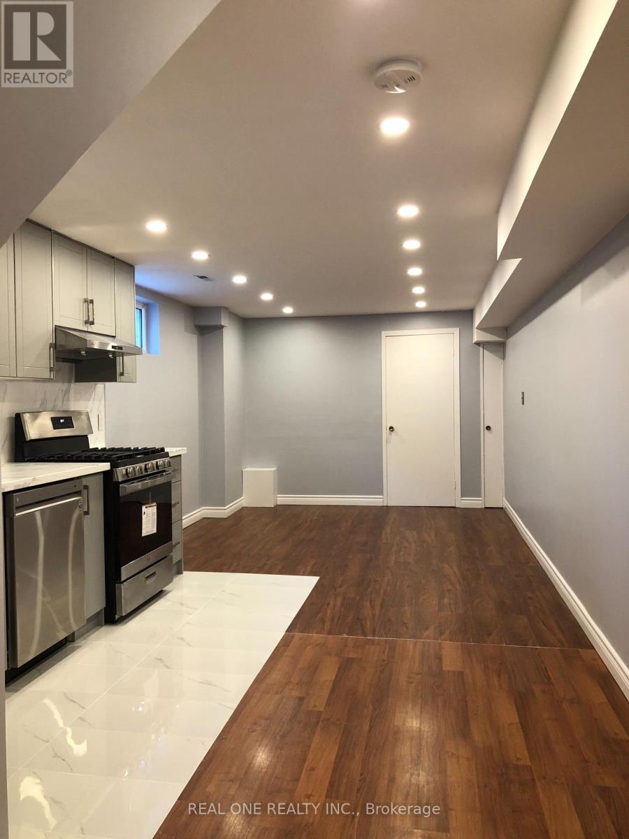 A kitchen with wood floors and white appliances.