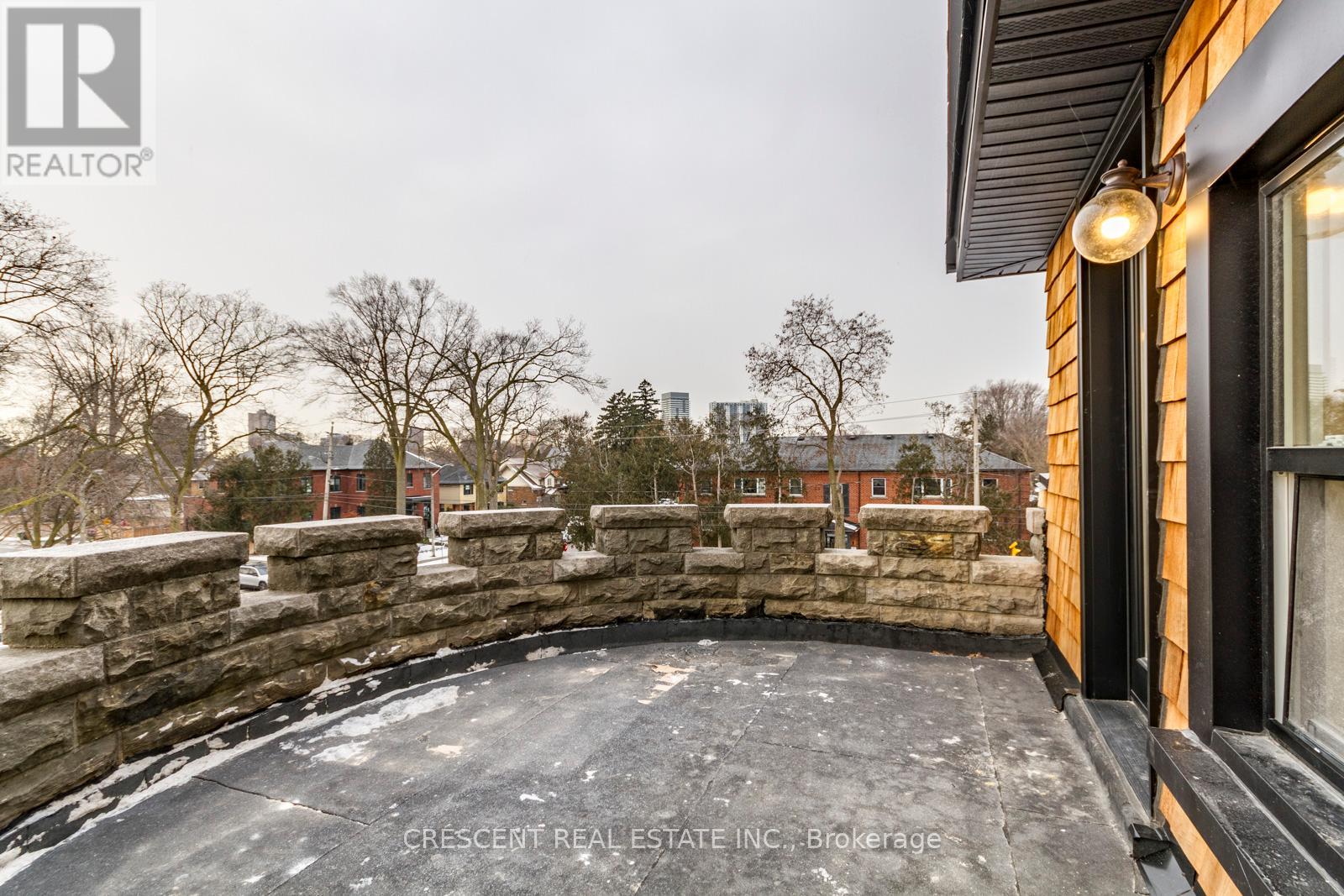A stone wall and a roof of a building.