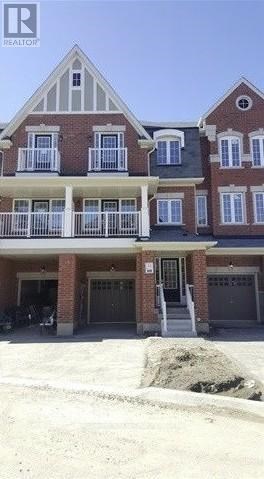 A two-story brick building with a balcony on the second floor.