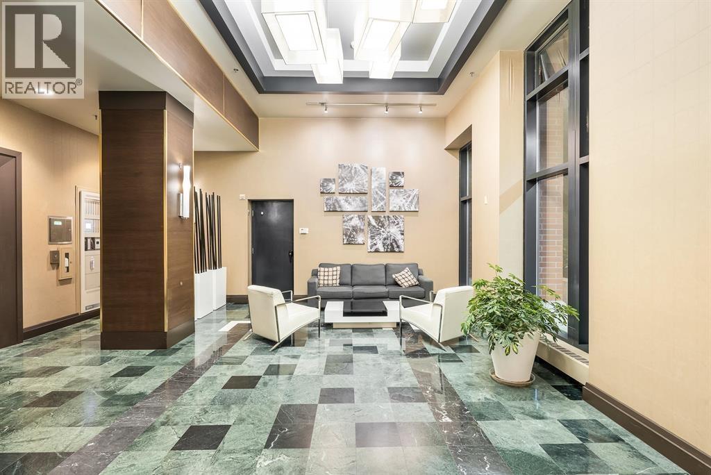 A living room with a couch and a potted plant.