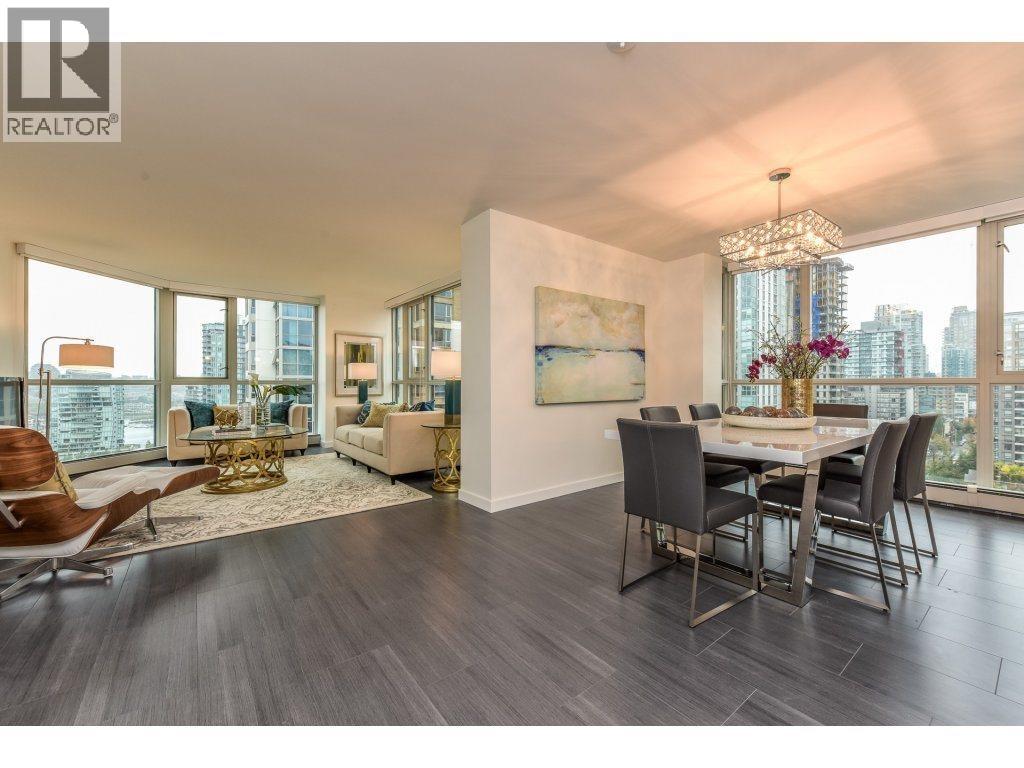 A well-lit, modern dining room with a view of the cityscape outside the large windows.