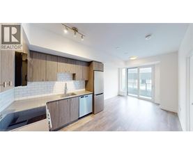 A modern kitchen with wooden cabinets and a large island.