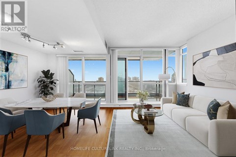 A well-lit, modern living room with a dining table and chairs.