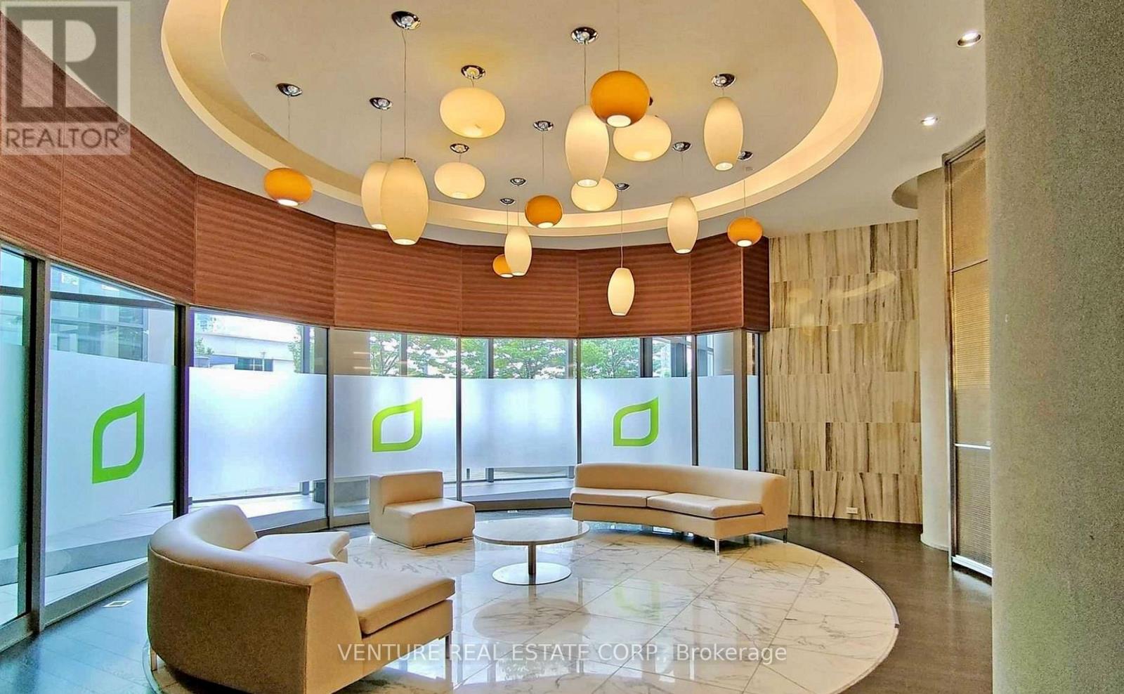 A modern living room with a circular ceiling and a large window.