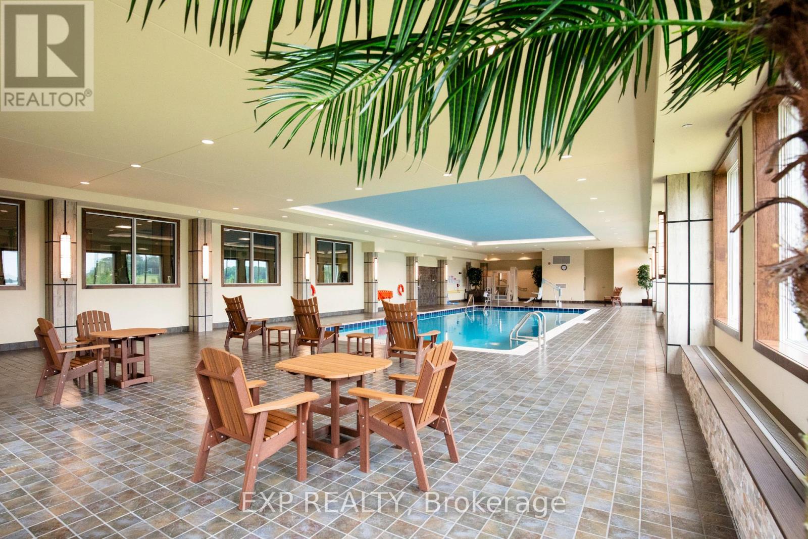 A large room with a pool table and chairs.
