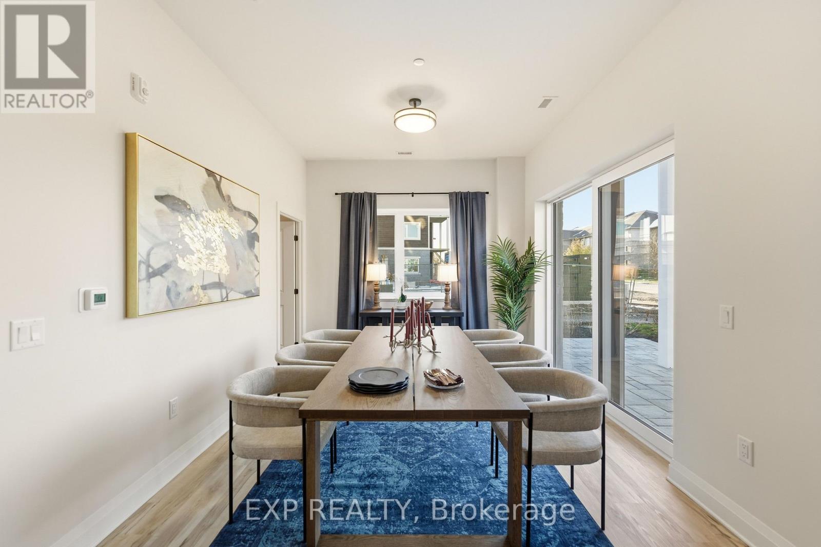 A dining room with a long table and chairs.