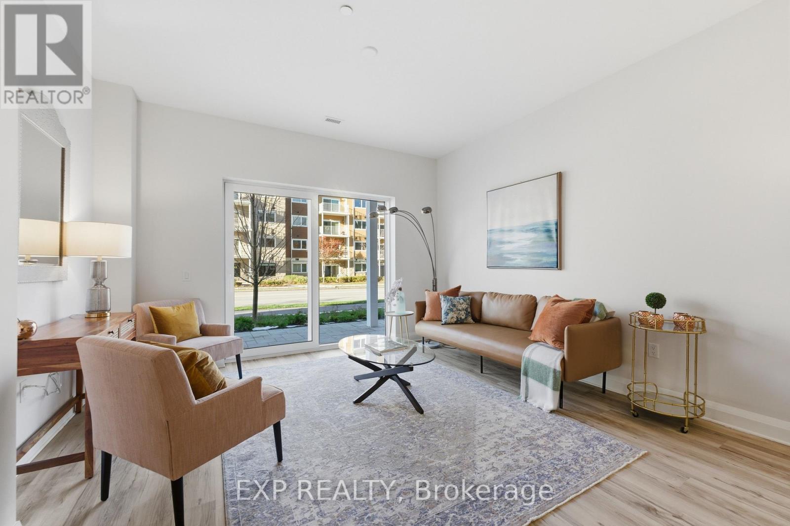A well-lit living room with a dining table and chairs.